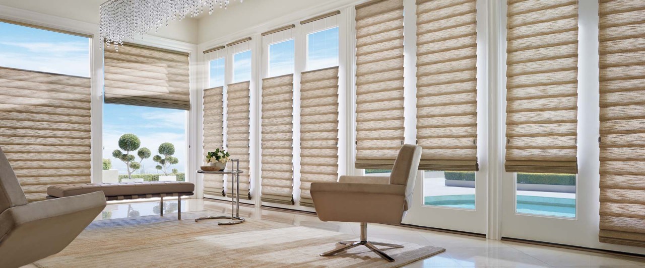 Large living room with tall windows featuring Vignette Modern Roman Shades top to bottom and bottom to top.